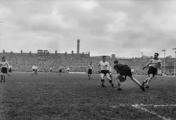David Teece has the ball under control as Bob Morton closes in