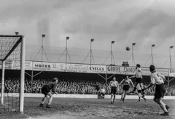 Bob Morton rises to meet this high ball into the penalty area