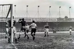 Mike Cullen about to bundle the keeper and the ball into the net for Town`s second goal
