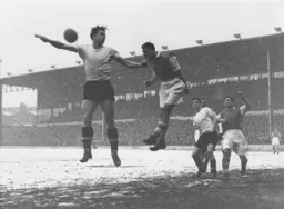 Bob Morton is beaten to the ball by Bill Selkirk