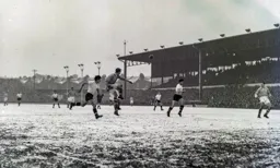 The ball is cleared as Gordon Turner and Bob Morton go in the wrong direction
