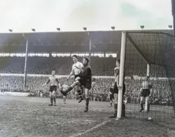 Roy Wood catches the ball under pressure from Jimmy Adam