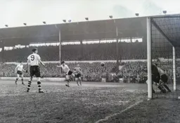 Jimmy Adam`s header is on target but John Charles and Roy Wood are poised to block it