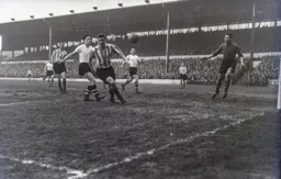 Gordon Turner tussles for the ball in the penalty area