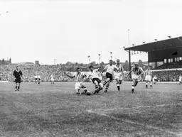 Gordon Turner and Tony Marchi are at full stretch to try and win the ball