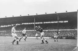 Gordon Turner runs in but Ted Ditchburn has firm hold of the ball