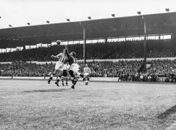 That looks painful as Ted Ditchburn appears to put his fist into the face of a team mate