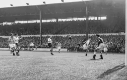 The ball goes across the Spurs penalty area with neither Gordon Turner or Peter MacEwan able to get close