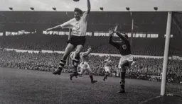 Gordon Turner gives away a free kick as he handles the ball