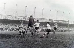 Bert Williams has the ball under control with Gordon Turner and Jimmy Adam in close proximity