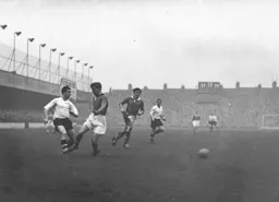 Bob Morton passes the ball across the penalty area