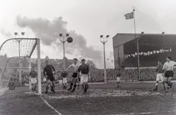 Jimmy Adam watches the ball drift out of play as a train passes by