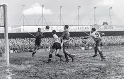 Johnny Anderson catches the ball as Mick Cullen and Bob Morton seek an elusive goal