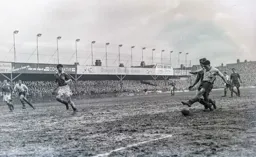 Gordon Turner ploughs his way through the mud to attack the City goal