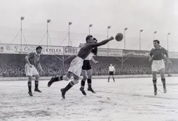 Ray Wood fists the ball away from Gordon Turner and United repel another Town attack