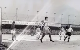Roy Davies looks on as Brian Gibson clears for the visitors