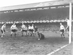 Ron Baynham smothers the ball as future Hatter Billy Bingham rushes in