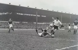 Nigel Sims dives at the feet of Jim Pemberton