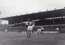 Gordon Turner leaps to try and win a header