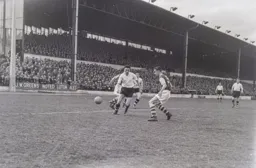 The ball gets away from Reg Pearce and Jimmy Adamson