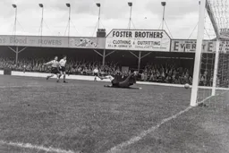 Gordon Turner shoots past Willie Fraser for his third and Town`s fifth goal