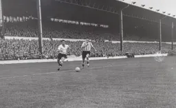 Bob Morton comes away with the ball. Joe McDonald is in hot pursuit