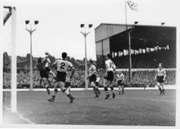 Wolves keeper Bert Williams punches the ball clear