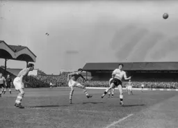 All Gordon Turner can do is look up at the ball following John Hewie`s clearance