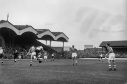 Gerry McCarthy heads the ball away under pressure from Bob Morton