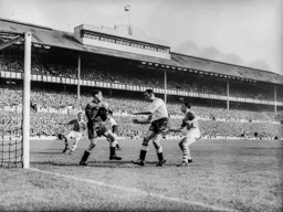 No way through here for Bob Morton as Ted Ditchburn holds on to the ball