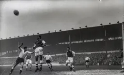 Dave Bowen heads the ball clear as Bob Morton cannot get off the ground