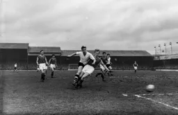 Bob Morton is held off the ball by Stan Crowther