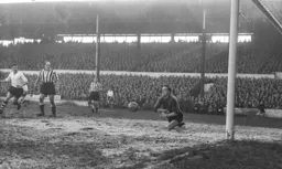 Allan Brown and Jimmy Scoular watch as Ronnie Simpson prepares to save the ball