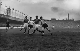 Mick Cullen and Gordon Turner move in to challenge Duncan Edwards