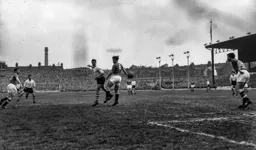 Allan Brown plays the ball past Duncan Edwards