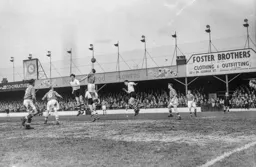 Gordon Turner is beaten to the ball by Bryan Edwards
