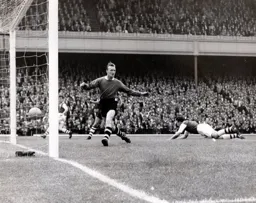 Ron Baynham is helpless as Vic Groves scores Arsenal`s first goal