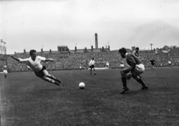 George Farm comes racing out of his goal to block this effort by Allan Brown