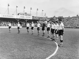 The Town team observe a minutes silence following the deaths of director Henry Richardson and Jock Finlayson a member of the 1936-37 promotion winning team