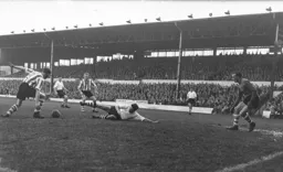 Gordon Turner goes to ground as Jack Martin prepares to clear the ball