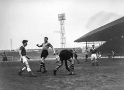 County keeper Ken Grieves gathers the ball before Gordon Turner can react