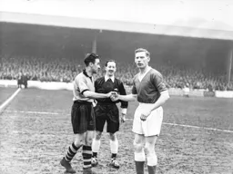 Syd Owen and County captain Frank Clempson meet before the kick off. Referee Mr Crawford watches proceedings