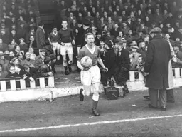 Syd Owen leads the team on to the pitch followed by Ron Baynham