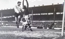 Allan Brown leaps high but Nigel Sims grabs the ball