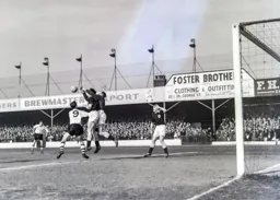 Ted Ditchburn and Maurice Norman combine to clear the ball away from John Groves