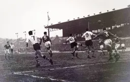 John Groves wins a header in a crowded penalty area