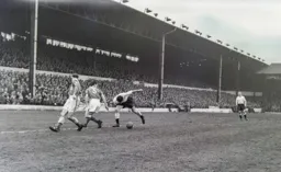 George Cummins keeps a close eye on the ball, Seamus Dunne watches from a distance