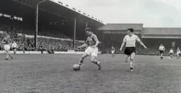 Cyril Rutter guides the ball away from Gordon Turner