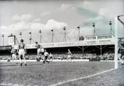 Allan Brown and Jimmy Adam look on as Ken Brown heads the ball clear for West Ham