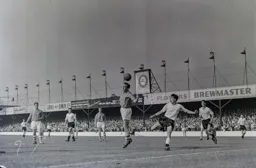 John Higgins heads the ball clear with Gordon Turner poised in case the ball came through